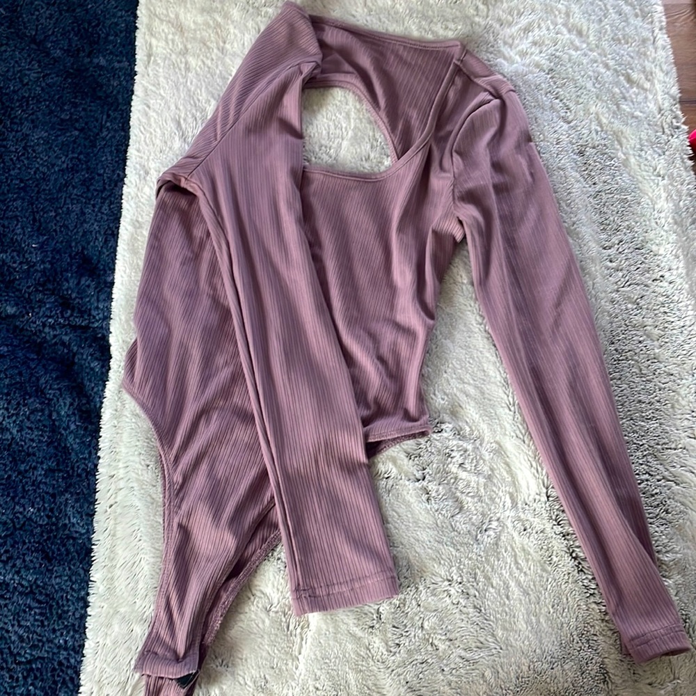 Purple one piece. open back, clip bottom, long sleeve.